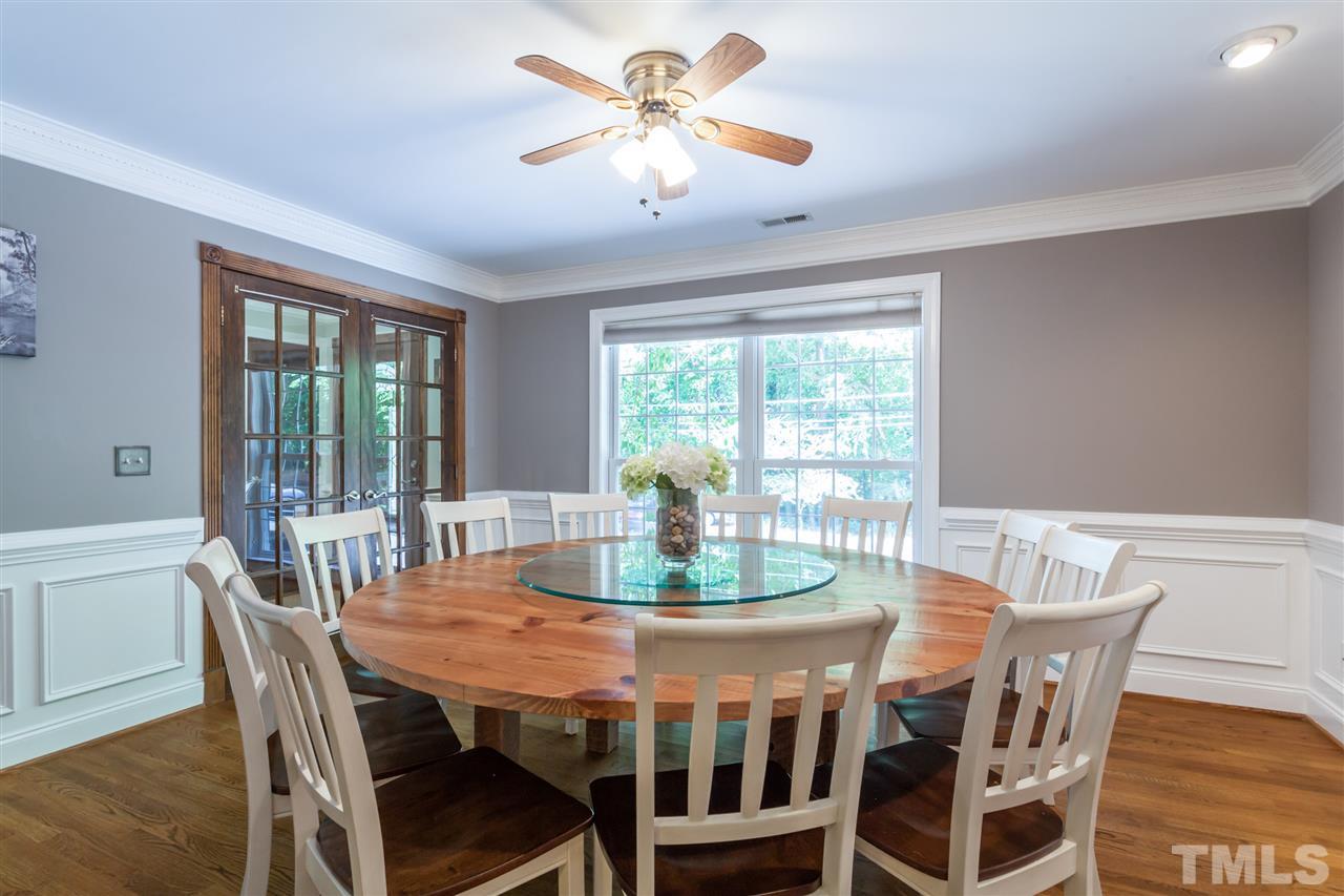 6609 King Lawrence Road Raleigh, NC 27607 - Photo 9 of 25 a dining room with furniture a rug and a large window