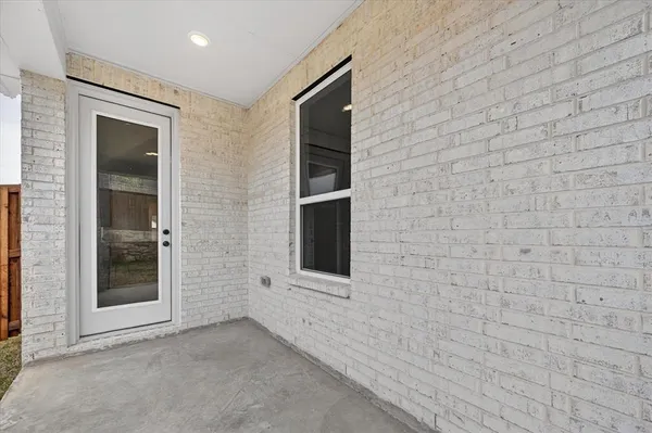 a view of an empty room with brick wall and closet