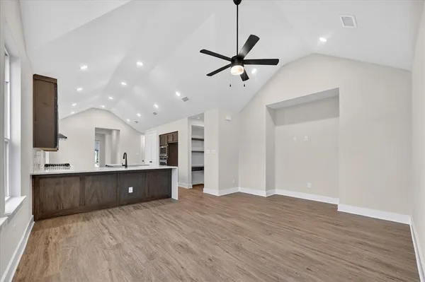 a view of a kitchen with a sink and wooden floor