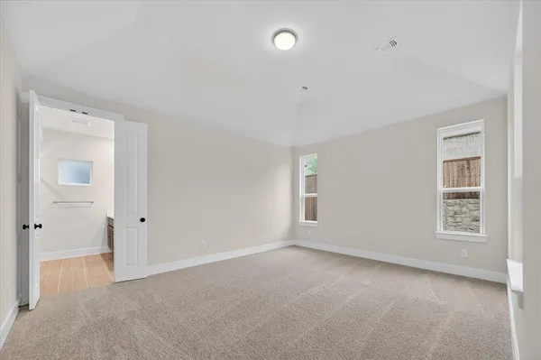 an empty room with windows and closet