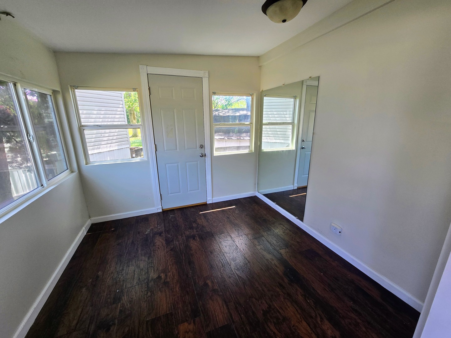 182 Windward Road Lakemoor, IL 60051 - Photo 2 of 22 an empty room with wooden floor and windows
