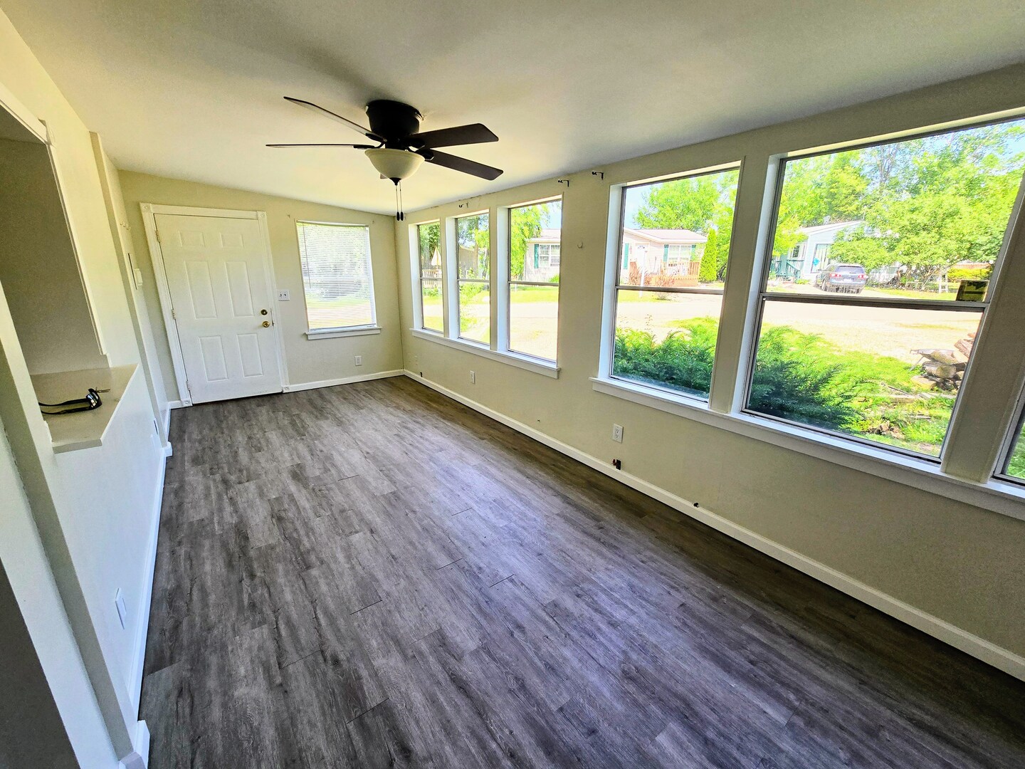 182 Windward Road Lakemoor, IL 60051 - Photo 4 of 22 a view of empty room with wooden floor and fan