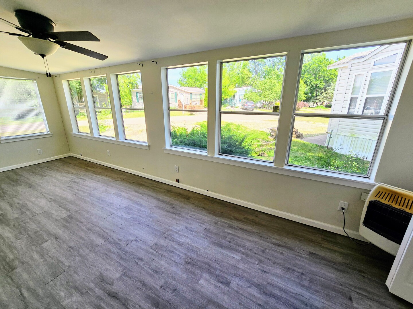 182 Windward Road Lakemoor, IL 60051 - Photo 5 of 22 a view of an empty room with wooden floor and a window