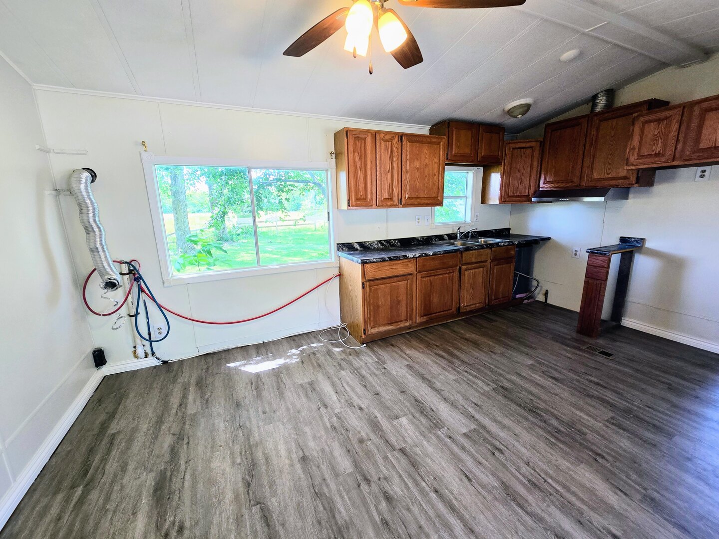 182 Windward Road Lakemoor, IL 60051 - Photo 7 of 22 a kitchen with stainless steel appliances granite countertop a stove and wooden floors