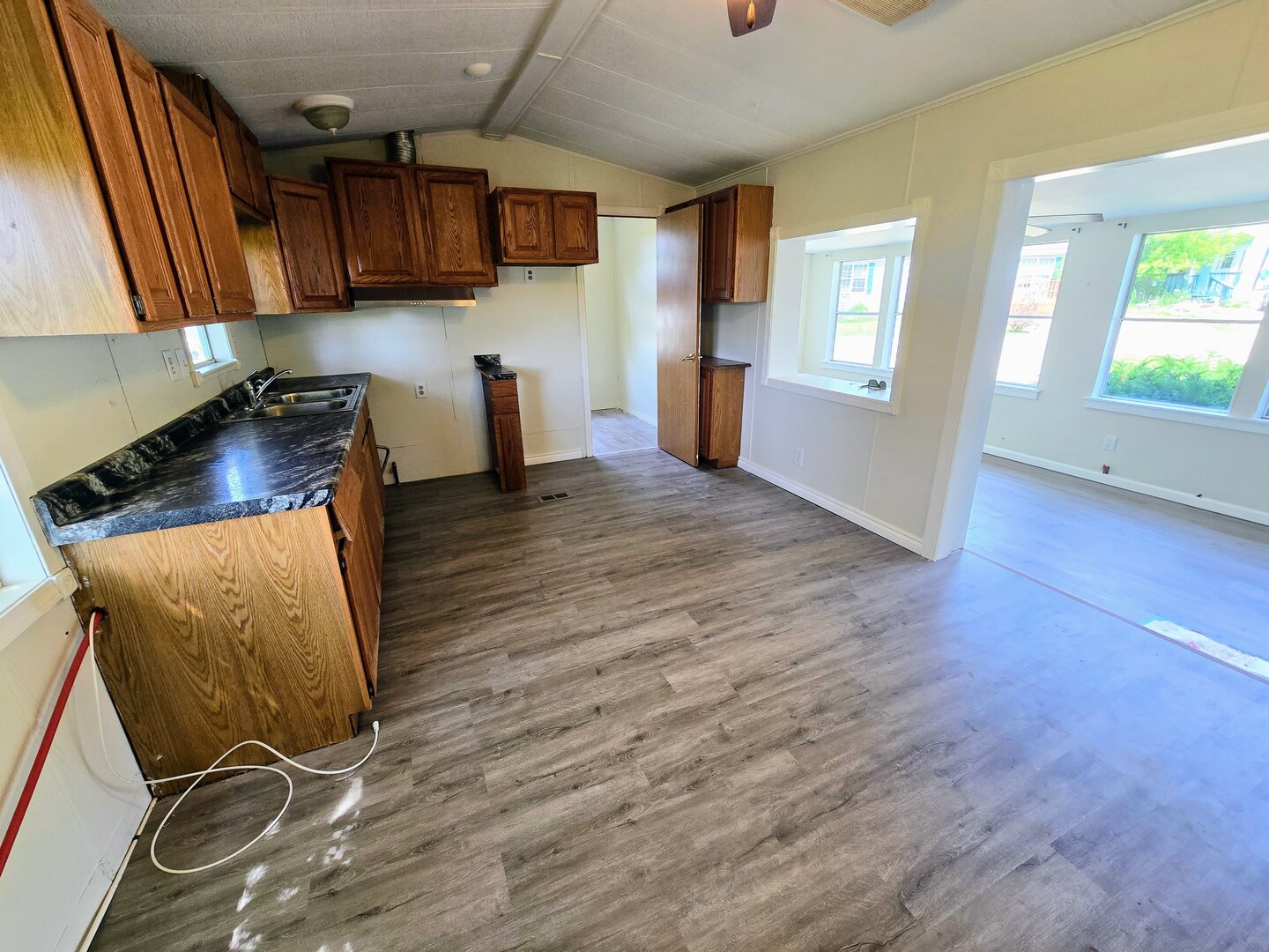 182 Windward Road Lakemoor, IL 60051 - Photo 8 of 22 a kitchen with granite countertop wooden floors and wide window