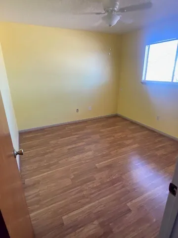 a view of a room with wooden floor