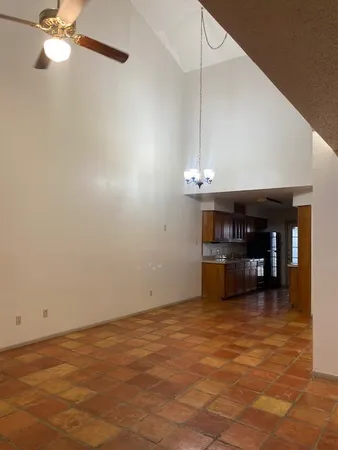 a view of a room with a ceiling fan and a rug