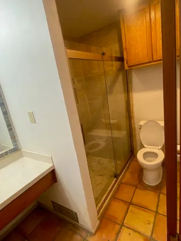 a bathroom with a toilet and a shower