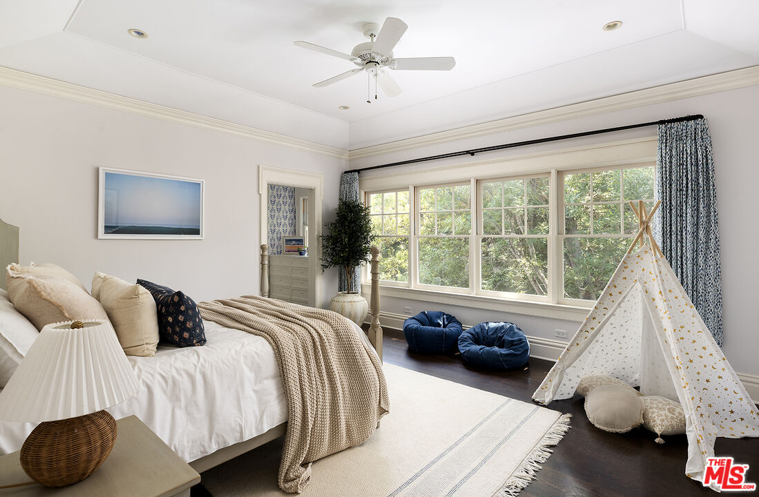 2041 Mandeville Canyon Road Los Angeles, CA 90049 - Photo 26 of 46 a bedroom with a bed and glass walk in closet