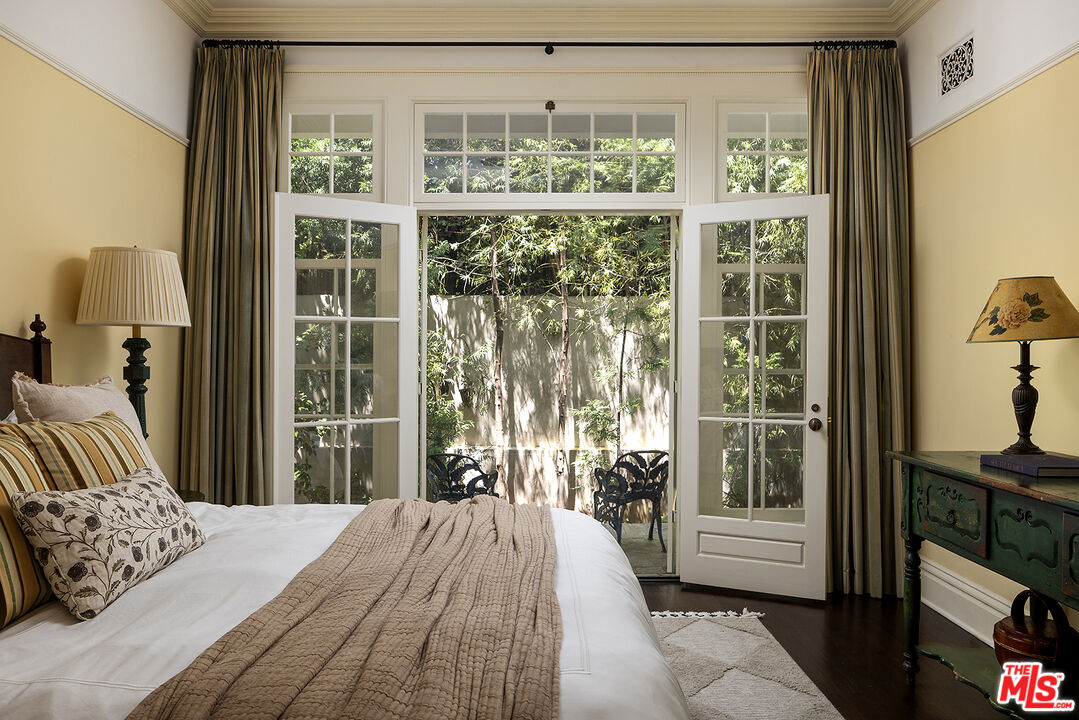 2041 Mandeville Canyon Road Los Angeles, CA 90049 - Photo 30 of 46 a bedroom with a bed and a large window