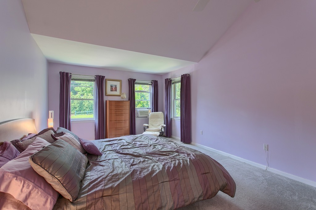 109 North Road Chelmsford, MA 01824 - Photo 18 of 30 a bed sitting in a bedroom next to a window