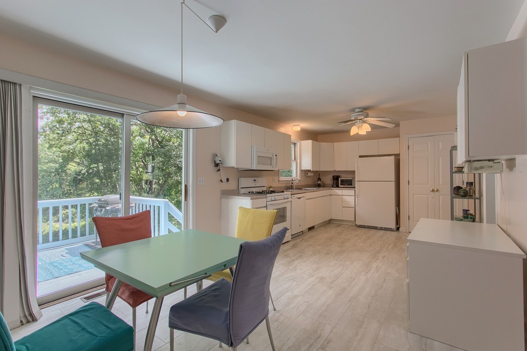 109 North Road Chelmsford, MA 01824 - Photo 2 of 30 a kitchen with a table chairs a sink dishwasher refrigerator and cabinets