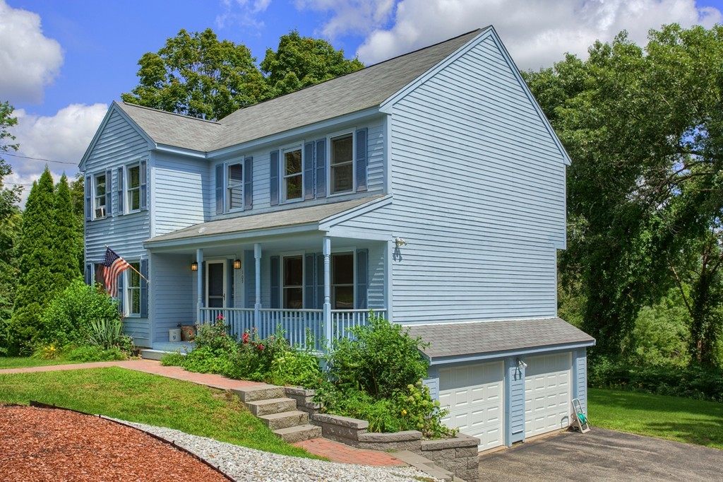 109 North Road Chelmsford, MA 01824 - Photo 26 of 30 a front view of a house with a yard and potted plants