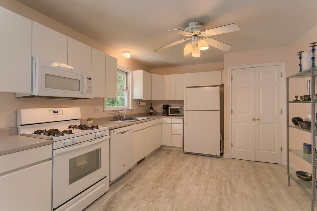 109 North Road Chelmsford, MA 01824 - Photo 3 of 30 a kitchen with cabinets stainless steel appliances and a window