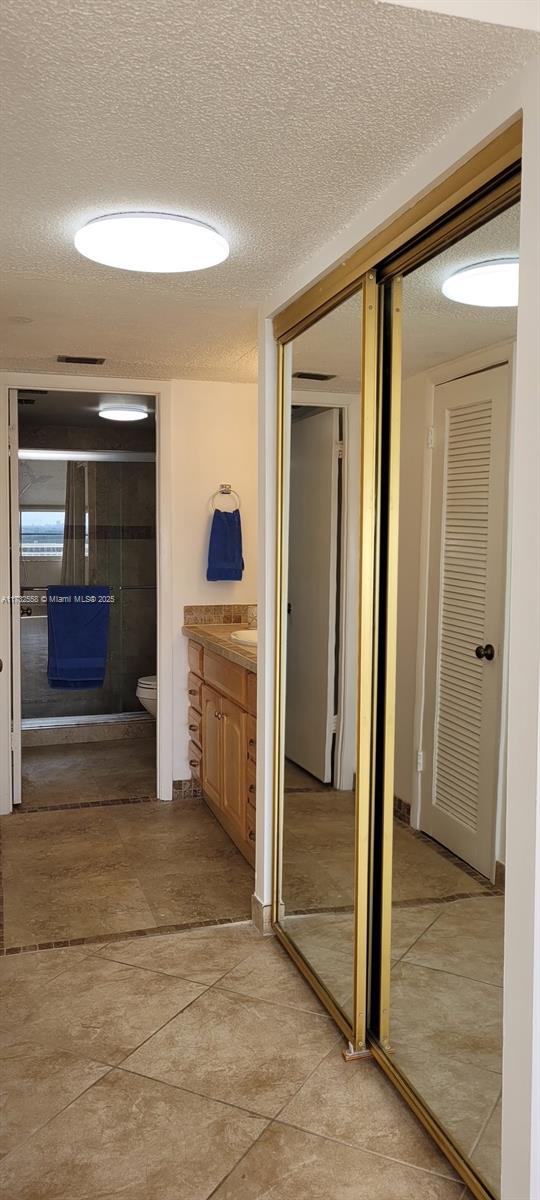 18031 Biscayne Boulevard, Unit PH03 Aventura, FL 33160 - Photo 12 of 21 a view of a hallway with a kitchen