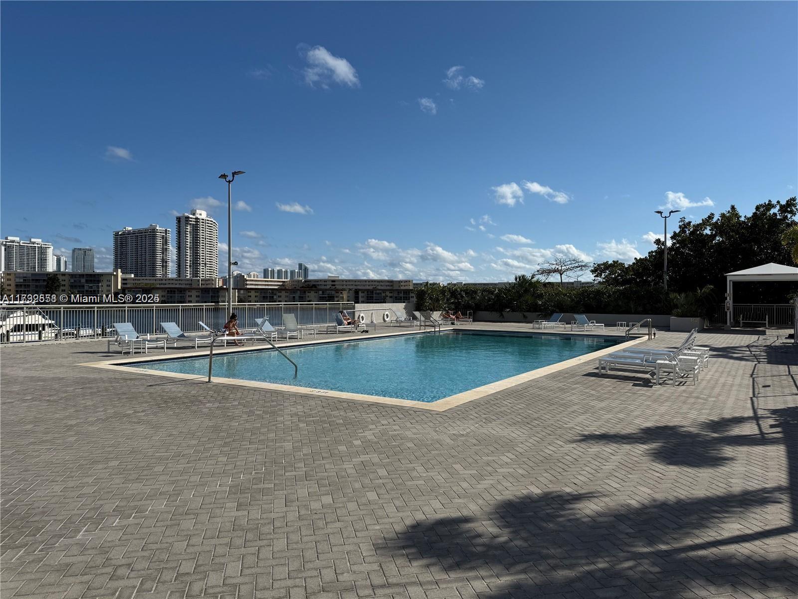 18031 Biscayne Boulevard, Unit PH03 Aventura, FL 33160 - Photo 2 of 21 a view of a lake with a nearby beach