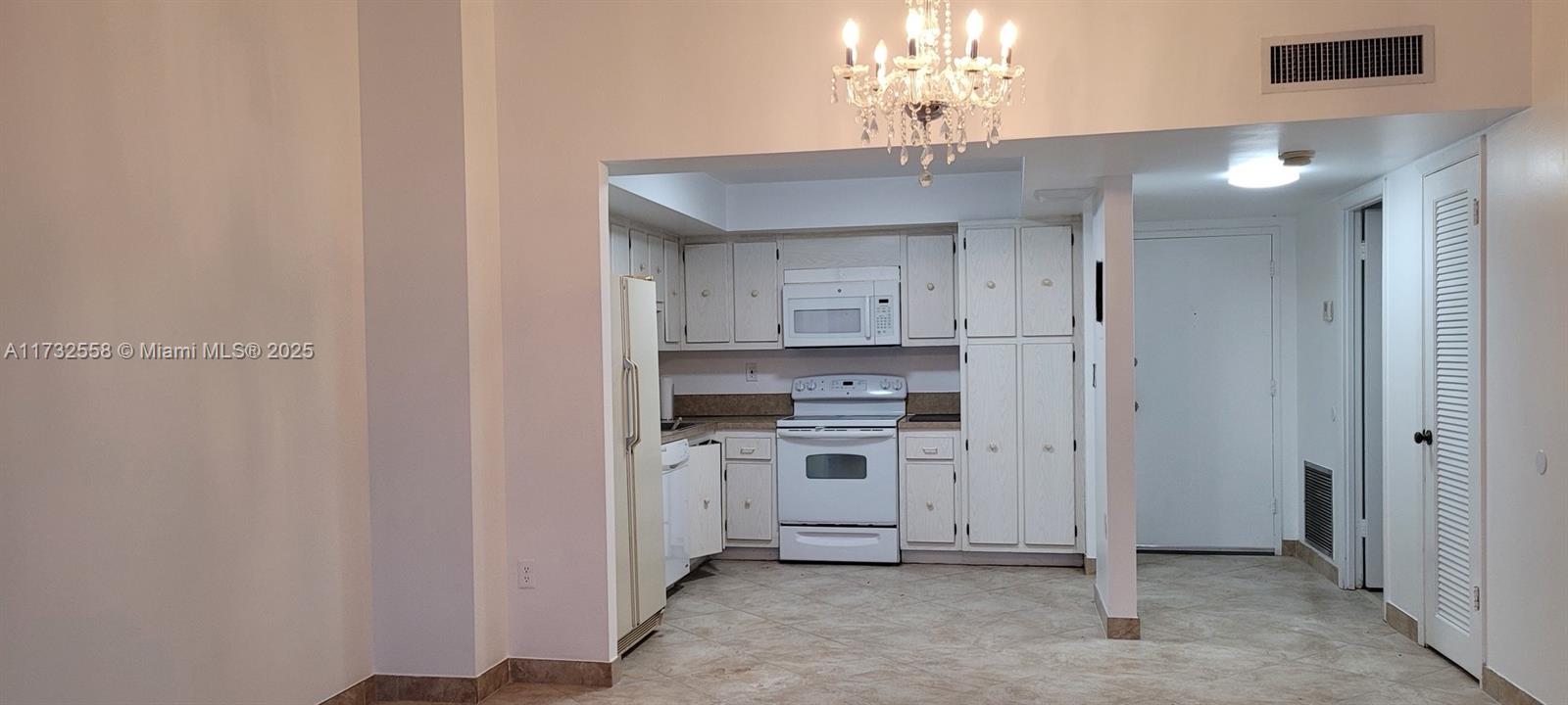 18031 Biscayne Boulevard, Unit PH03 Aventura, FL 33160 - Photo 8 of 21 a view of a kitchen with a sink and a refrigerator