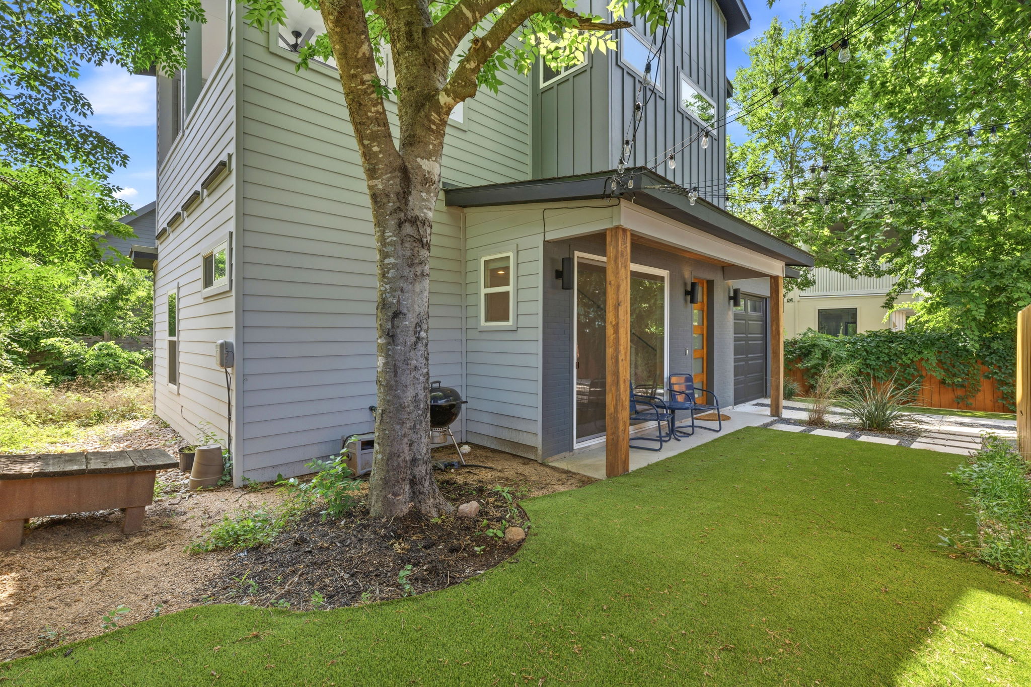 1707 Deloney Street, Unit 2 Austin, TX 78721 - Photo 26 of 26 A private side yard with artificial turf and a covered patio offers a charming outdoor retreat.