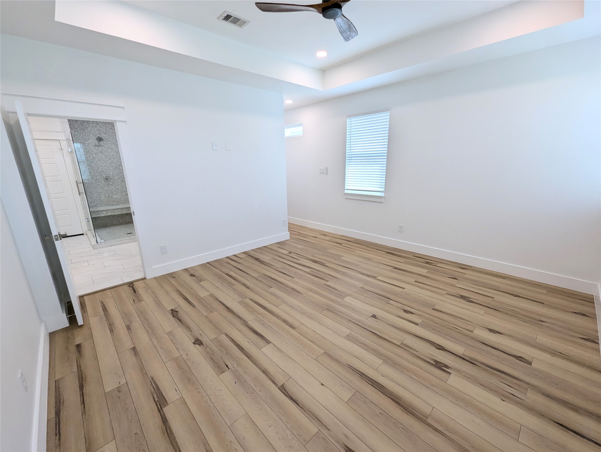 4913 Fisk Street Houston, TX 77009 - Photo 15 of 27 an empty room with wooden floor fan and windows