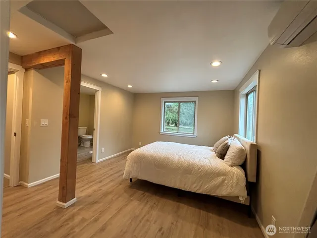 a bedroom with a bed and a window