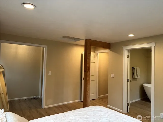 a white tub sitting next to a toilet