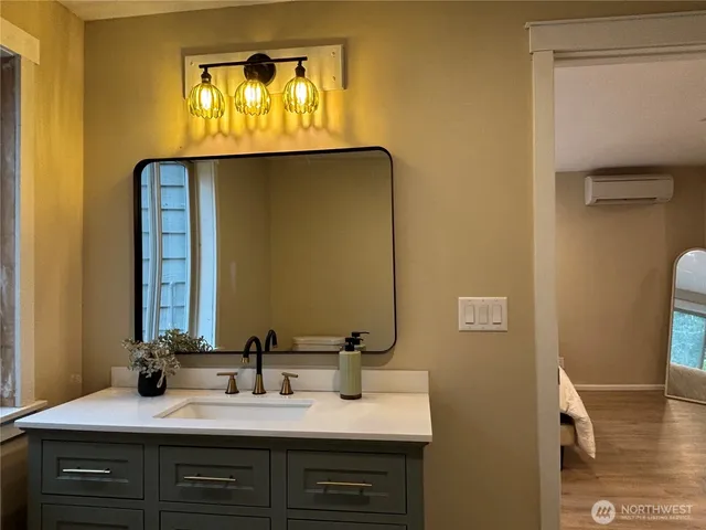 a bathroom with a tub sink and mirror