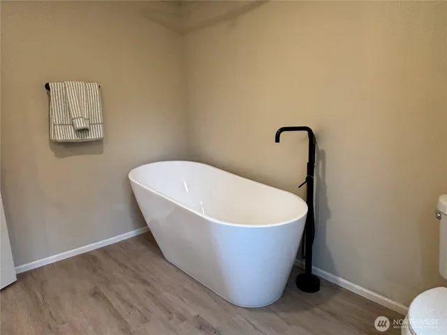 a bathroom with a sink mirror and toilet