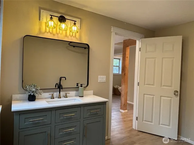 a bathroom with a sink and mirror