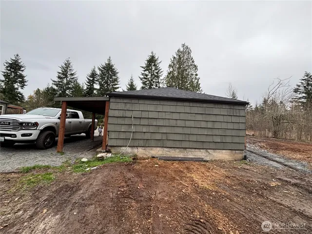 an empty room with wooden floor cabinet and windows