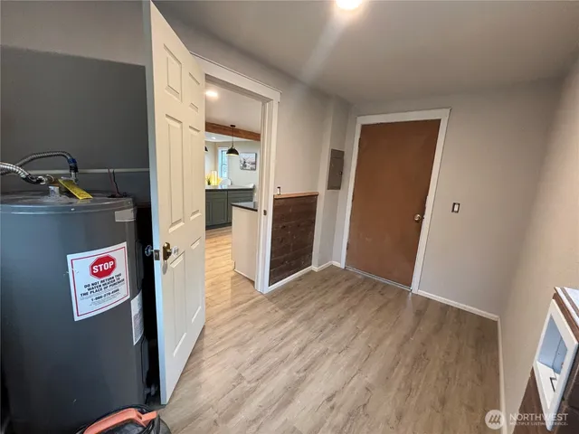 a front view of a house with a yard and trees