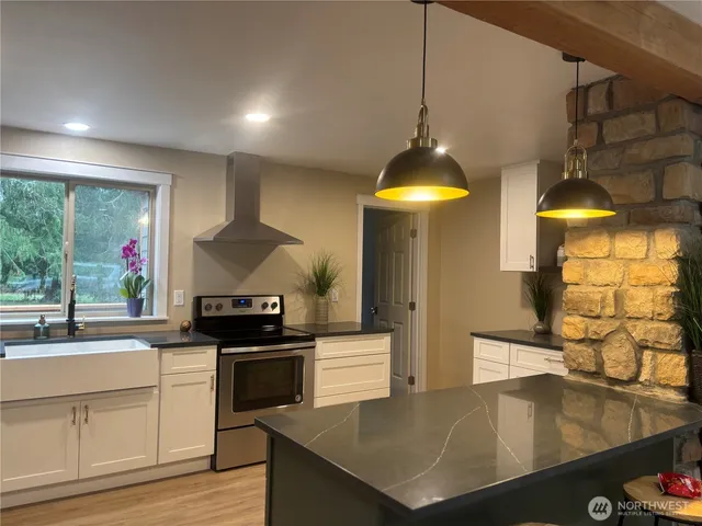 a room with pool table and windows