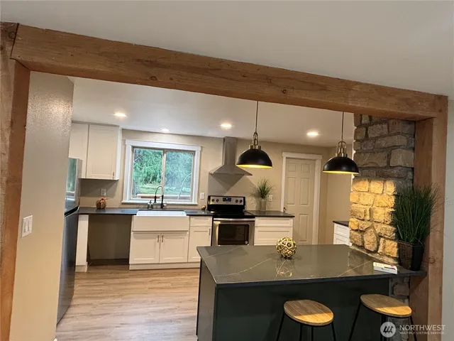 a view of a hallway with wooden floor and furniture