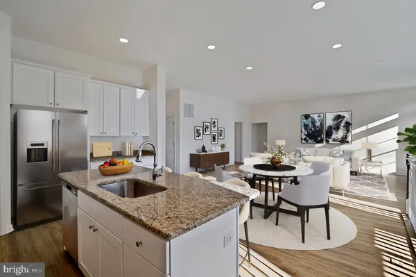 a kitchen with a table chairs and refrigerator