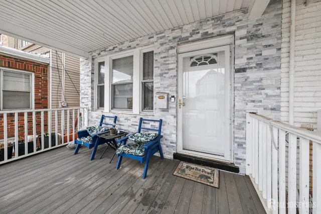 a balcony with furniture and wooden floor