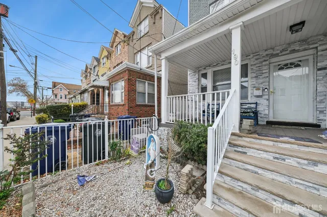 a view of a brick house with wooden floor and a table