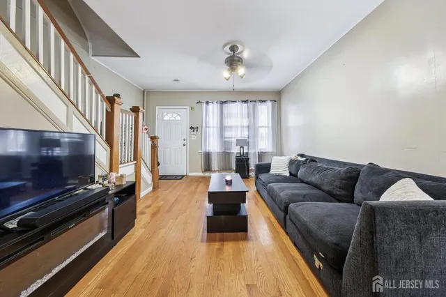 a living room with furniture and a flat screen tv