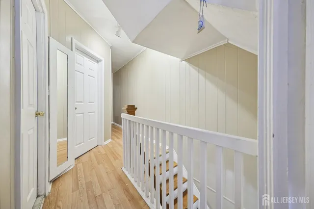 a view of a hallway with wooden floor and entryway