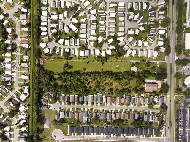 an aerial view of residential houses with outdoor space