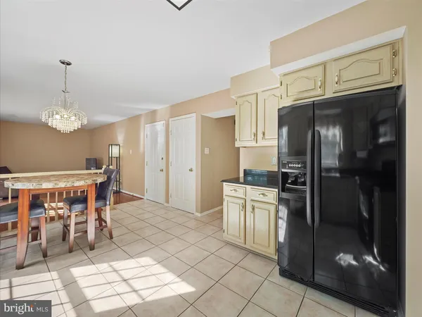 a kitchen with granite countertop a sink cabinets and stainless steel appliances