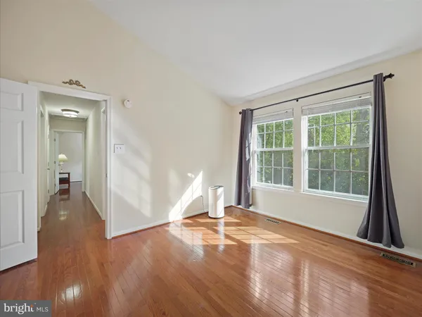 a view of a room with wooden floor