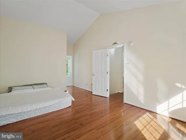 a bathroom with a granite countertop toilet a sink and a large mirror