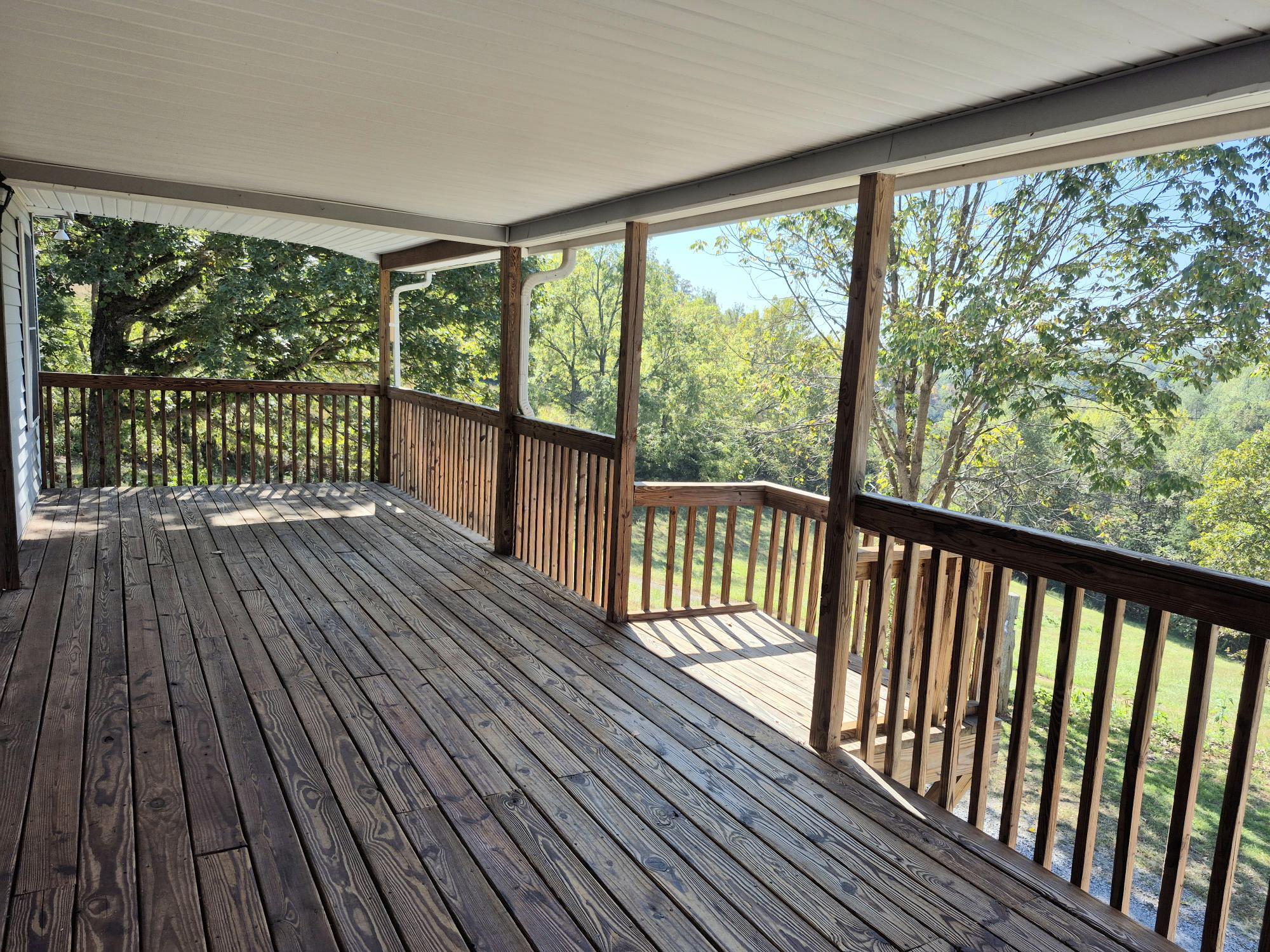 10048 Moneta Road Bedford, VA 24523 - Photo 11 of 51 a view of a wooden balcony with outdoor space