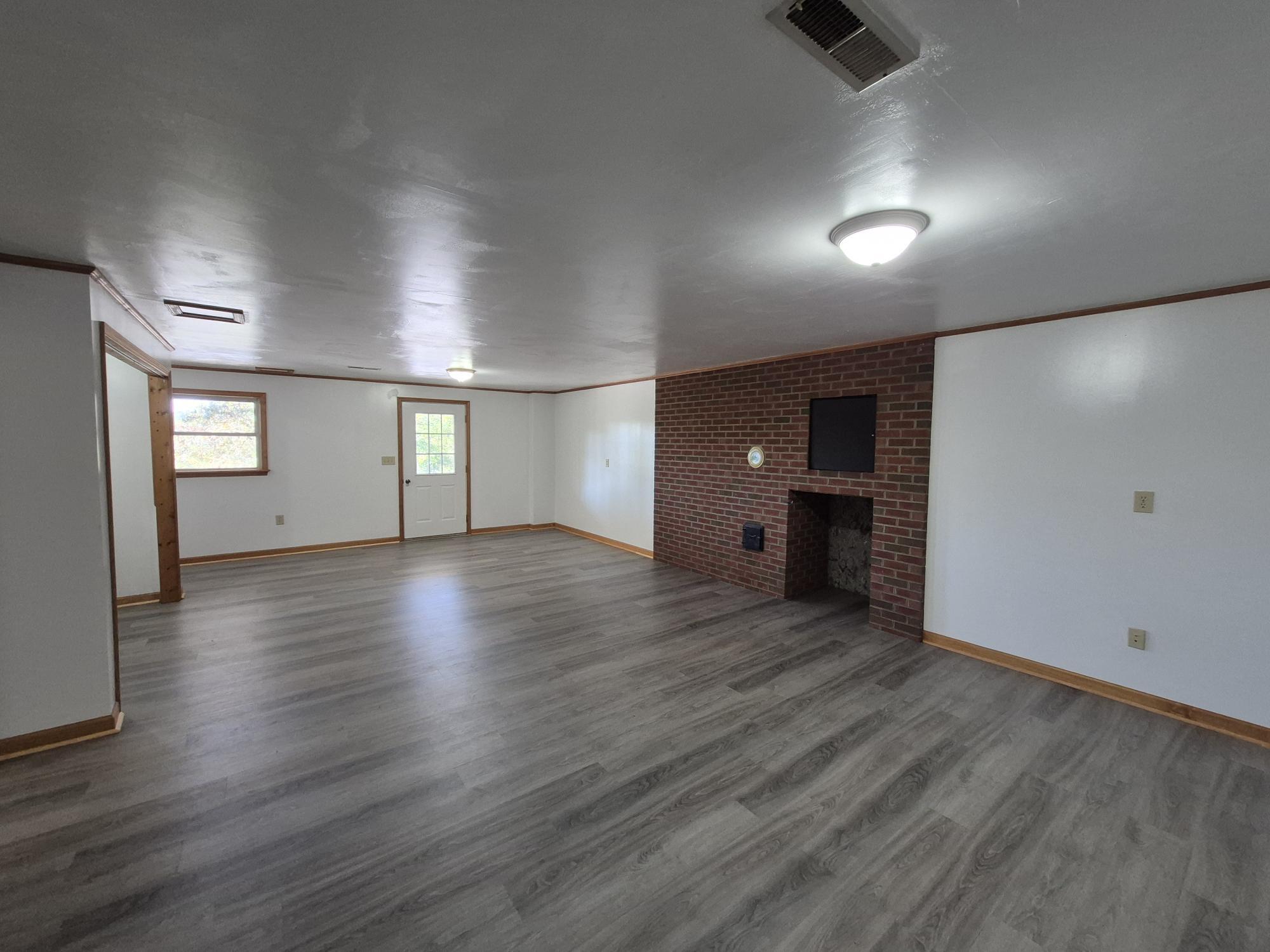 10048 Moneta Road Bedford, VA 24523 - Photo 13 of 51 an empty room with wooden floor and windows