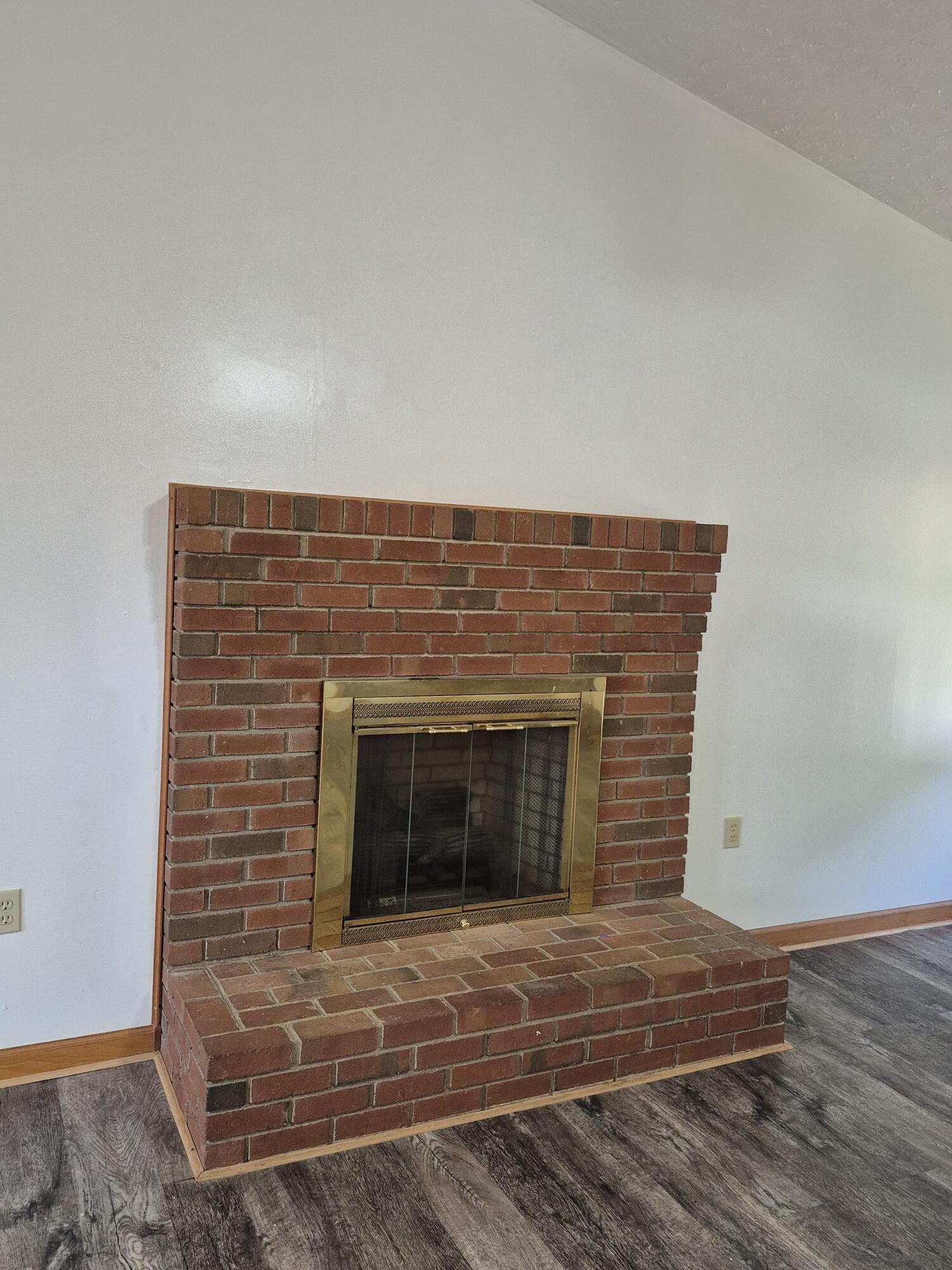 10048 Moneta Road Bedford, VA 24523 - Photo 15 of 51 a view of empty room with wooden floor and fireplace
