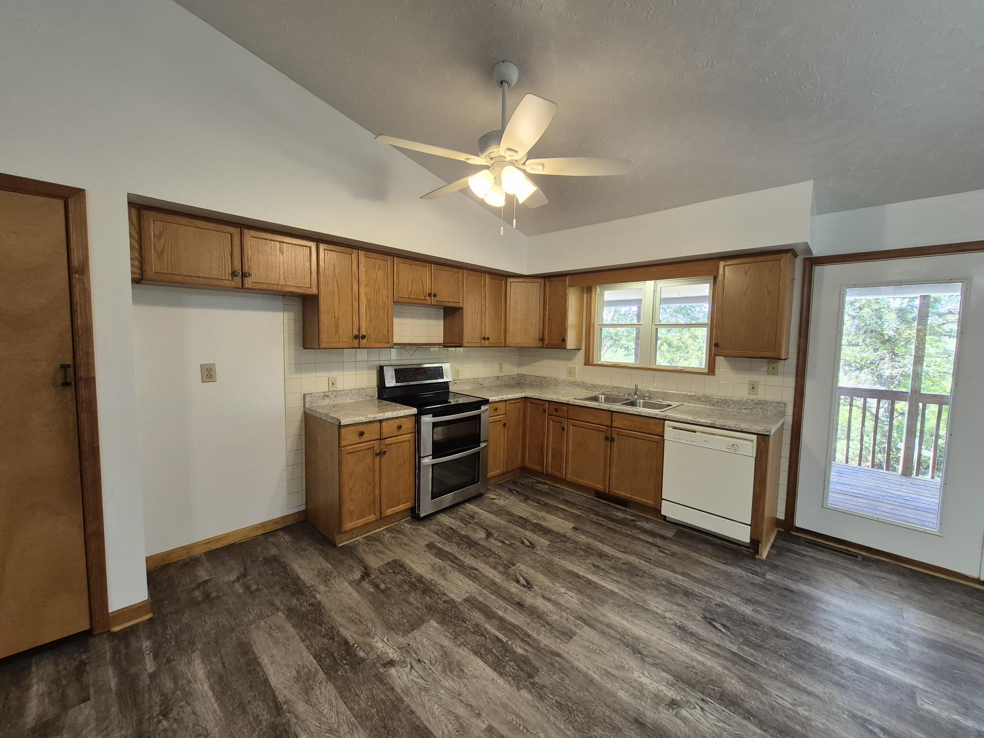 10048 Moneta Road Bedford, VA 24523 - Photo 16 of 51 a kitchen with a stove a sink and a refrigerator