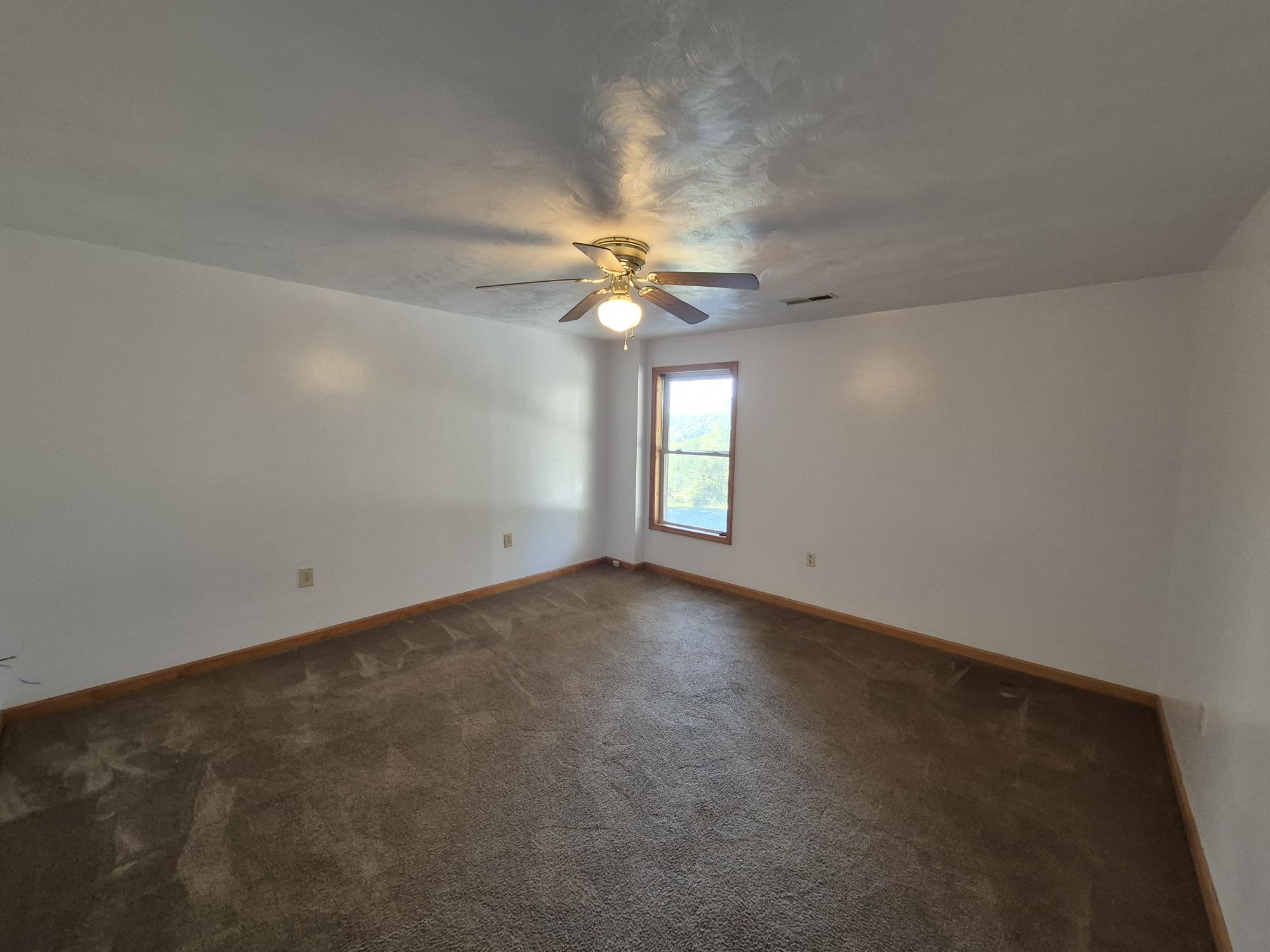 10048 Moneta Road Bedford, VA 24523 - Photo 28 of 51 an empty room with windows and fan