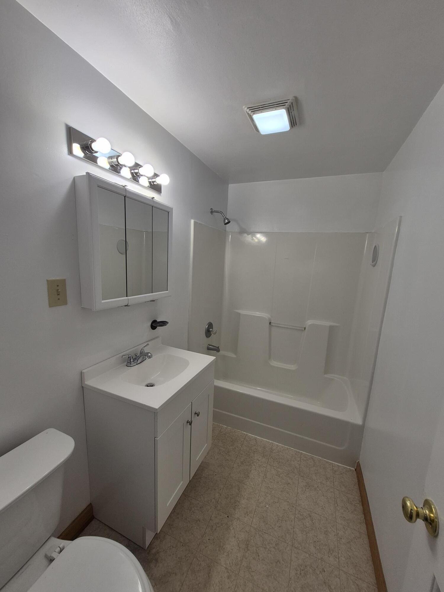 10048 Moneta Road Bedford, VA 24523 - Photo 29 of 51 a bathroom with a toilet a sink a mirror a bathtub and vanity