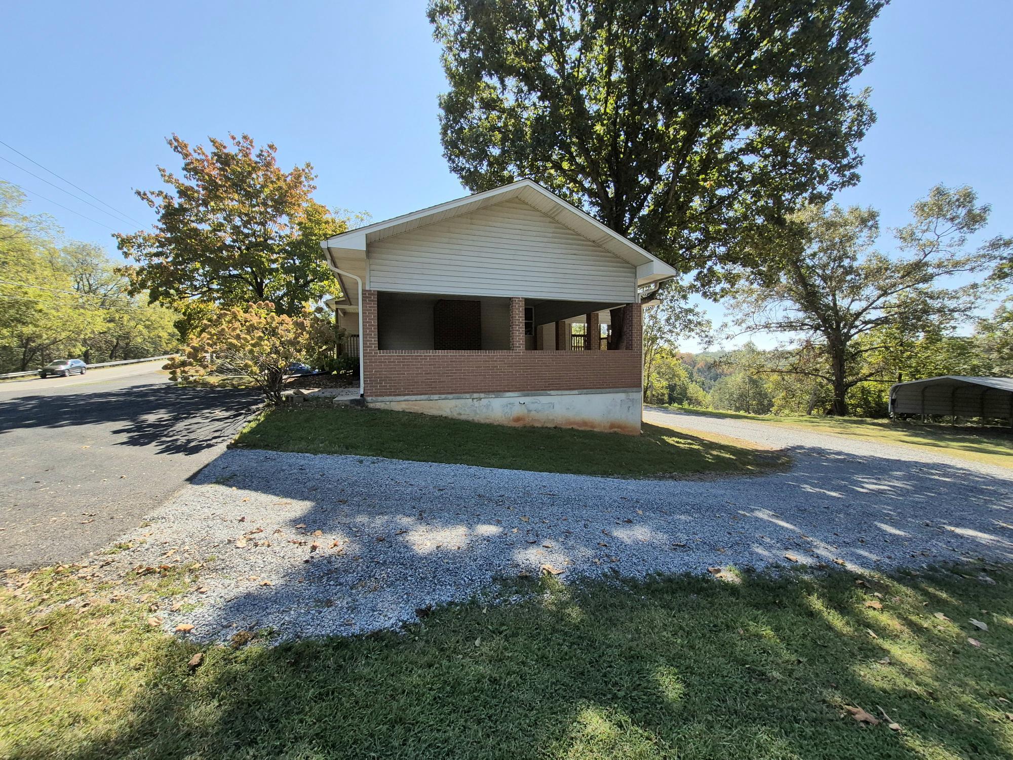 10048 Moneta Road Bedford, VA 24523 - Photo 47 of 51 a front view of a house with a yard and garage