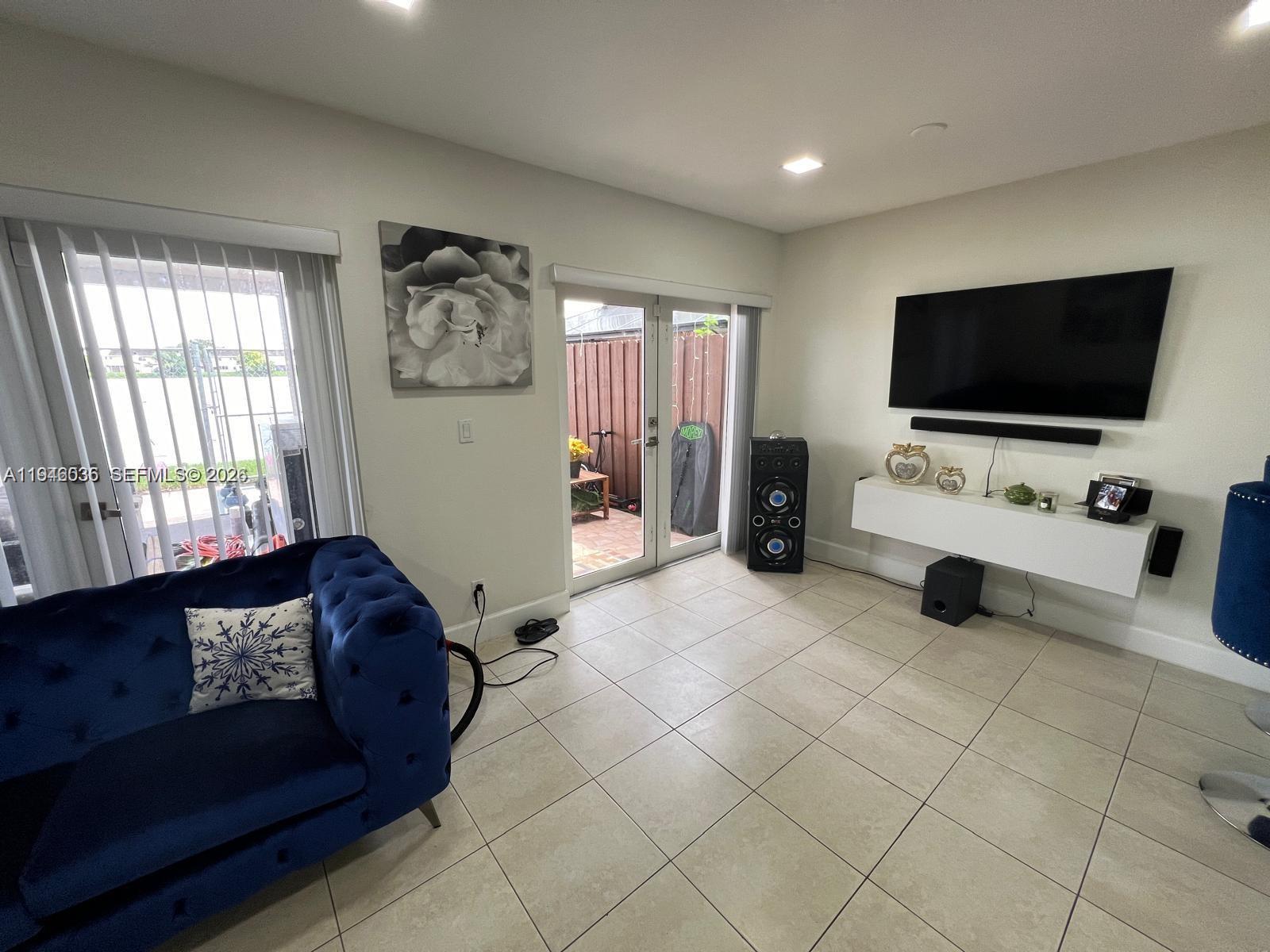 17401 Southwest 140th Court Miami, FL 33177 - Photo 21 of 42 a living room with furniture and a flat screen tv