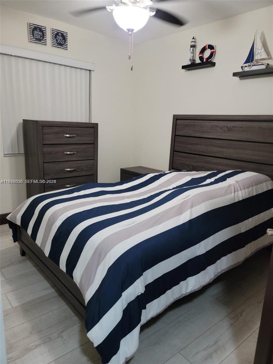 17401 Southwest 140th Court Miami, FL 33177 - Photo 26 of 42 a bedroom with a bed and a chandelier